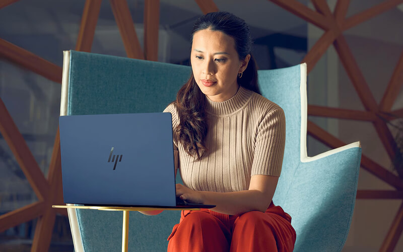 Business professionals working with HP devices in meeting