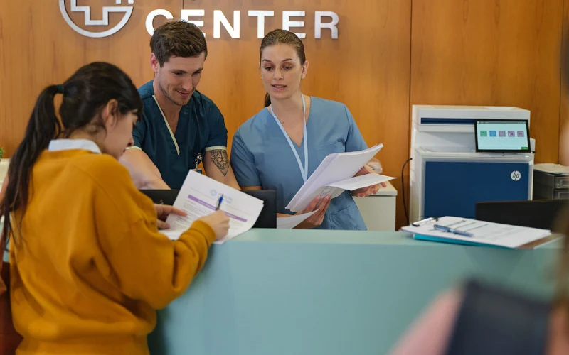 Healthcare worker on a laptop.