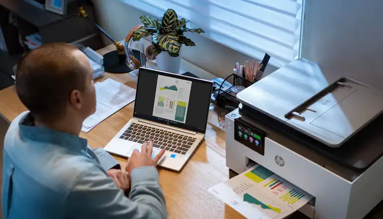 Man printing off of a HP printer from his laptop.