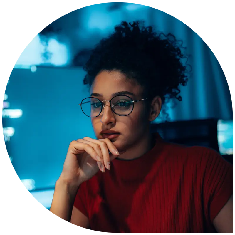 Woman in tech—programmer or cybersecurity professional—supporting Managed Exposure Defense. Explore solutions today.