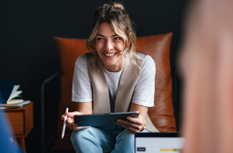 Business professional working off laptop remotely in modern office setting