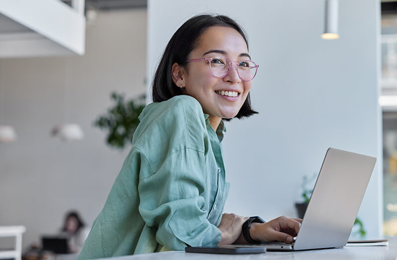 Businesswoman using a laptop to connect to remote work via Google Cloud