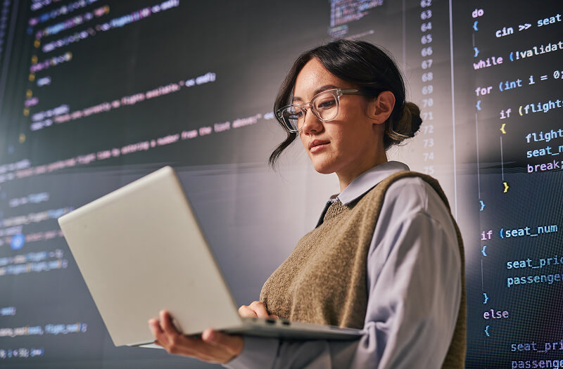 Business professionals collaborating on a Google Chromebook while discussing Google Cloud for business solutions