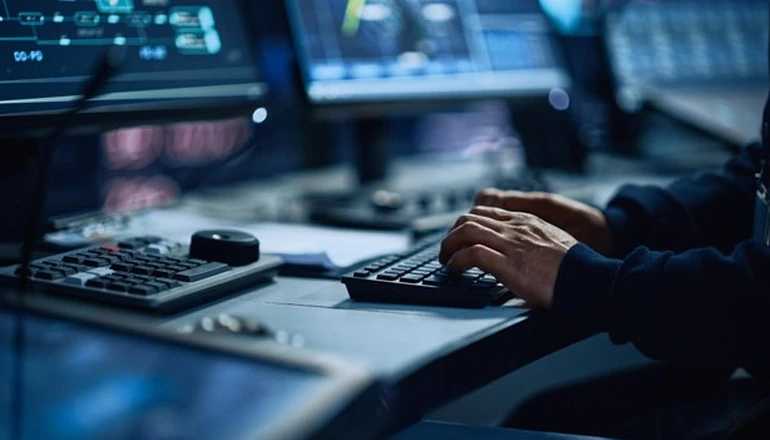 Hands typing on a computer.