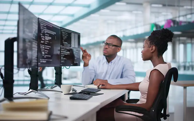 People on desktop doing coding work. 