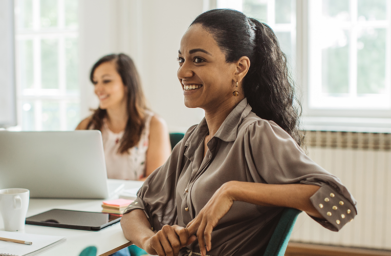Businesswoman using laptop wioth Gemini Enterprise in office