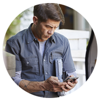 Businessman uses touch screen of mobile phone