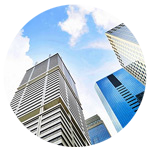 Worms eye view of skyscrapers rising to cloudy sky.