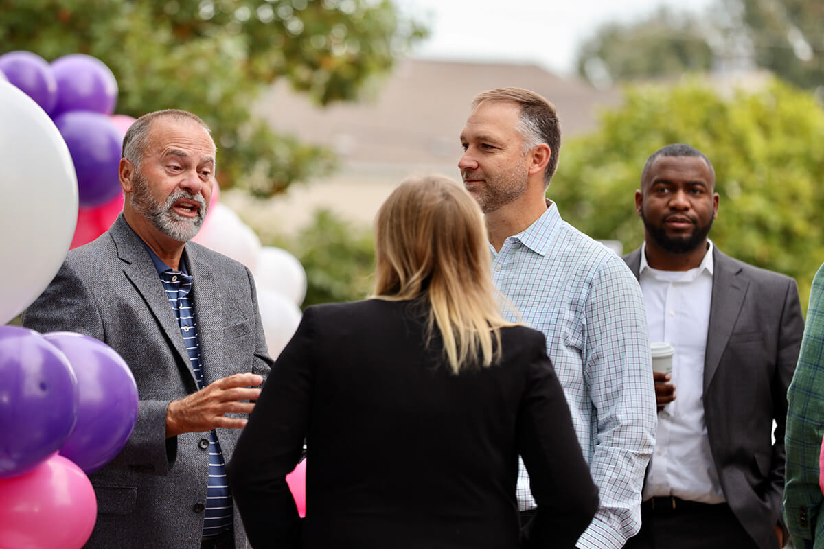 Conway, Arkansas Mayor Bart Castleberry talks with Insight team outside ribbon cutting ceremony of new Insight office