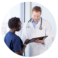 Doctor and nurse review patient data on tablet