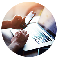 User on mobile phone and laptop