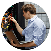 IT professional with laptop working in data center