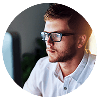 IT technician in glasses on desktop computer