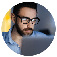 IT professional on laptop computer monitors possible data outages