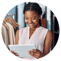 Clothing store owner holds tablet device