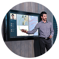 Man points to screen on wall