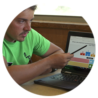 Camp instructor using a stylus to point to a presentation on notebook computer