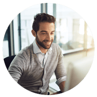 Close up of man smiling while looking at monitor