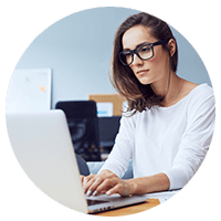 Woman in glasses on laptop computer