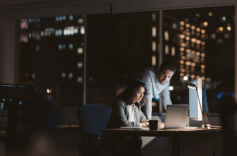 IPS will help you eliminate overspending, identify inefficiencies and align IT dollars with high-value opportunities. Two employees working at night