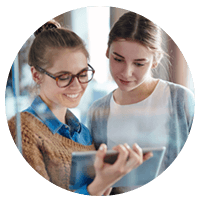 Two woman collaborating over tablet device