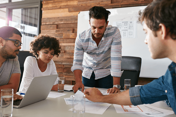 Dedicated post lauch team meets at table to discuss and monitor deployment