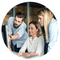 Three coworkers working over monitor screen