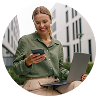 Woman using a laptop and mobile phone