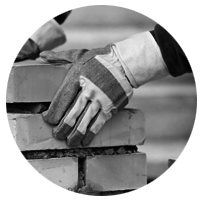 Close up of hands building a brick wall