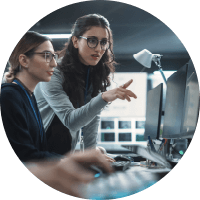 Two women with glasses working together