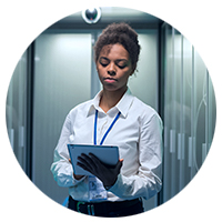 Woman using tablet in data center