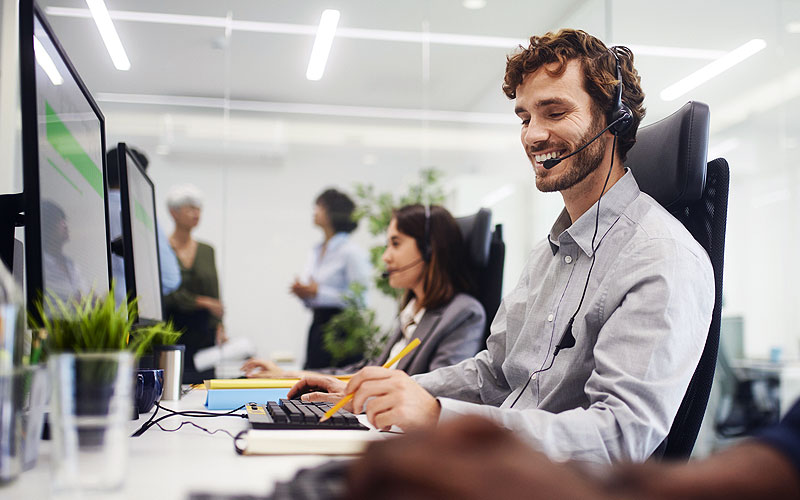 Support technician on headset helping resolve IT tickets