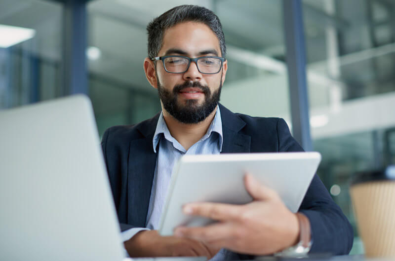 Business professional reviewing the use of applications in the cloud.