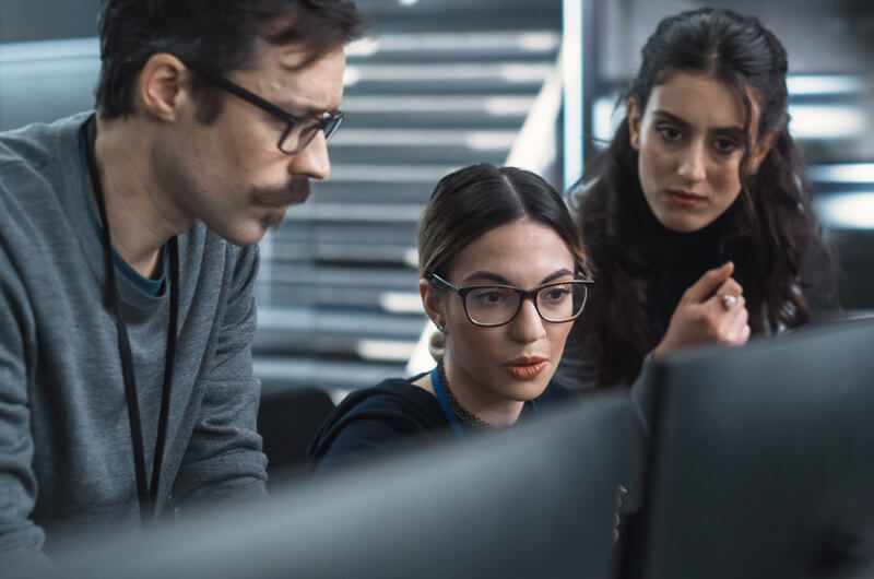 Network administrator reviewing company data for data breaches or leaks