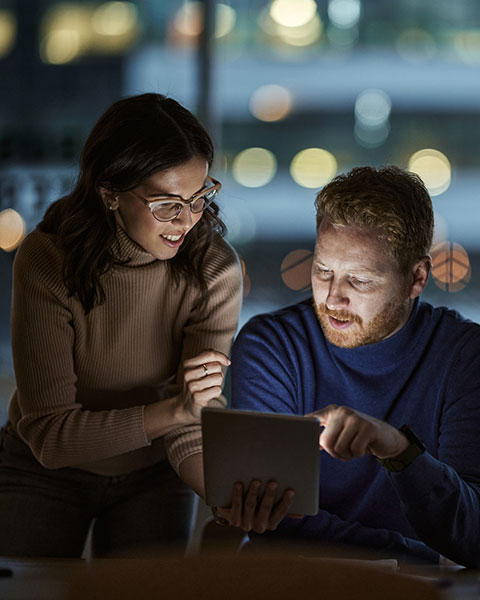 two users using tablet in office