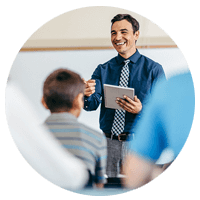 Close up of smiling teacher working on desktop computer