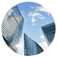 Modern business buildings skyline with clouds reflected through windows and in the sky