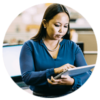 Businesswoman using Box on her tablet computer to download files