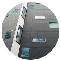 Modern business building with clouds reflected in multiple windows