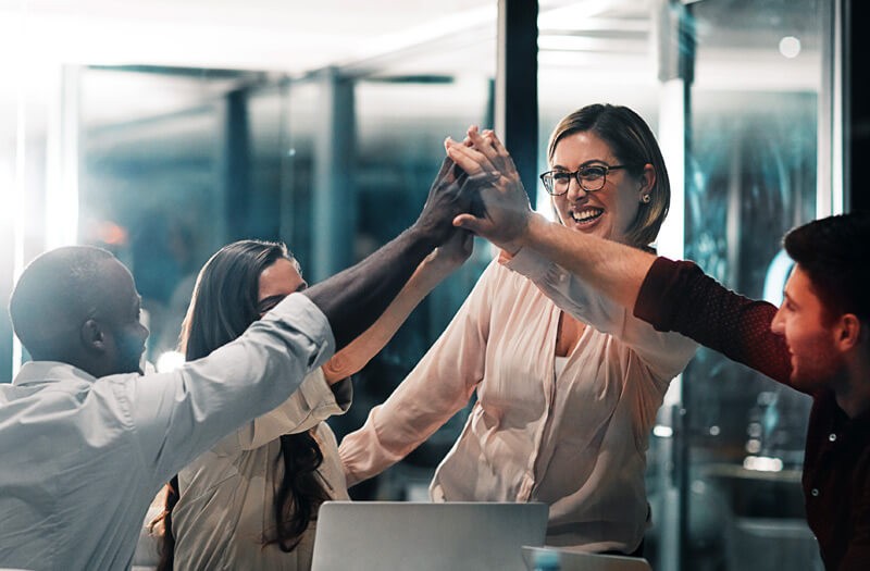 Business team give eachother high five