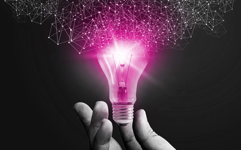Uncover your competitive edge. Hand holding a lightbulb