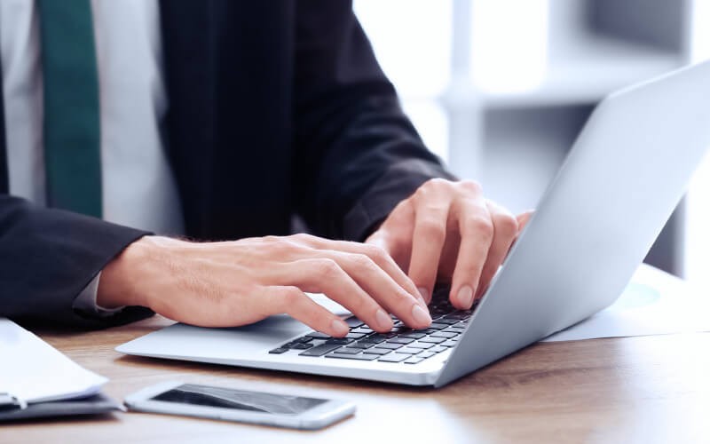 Man in suit using his laptop
