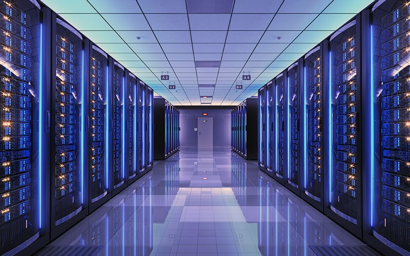 An empty server room lit in blue lights.