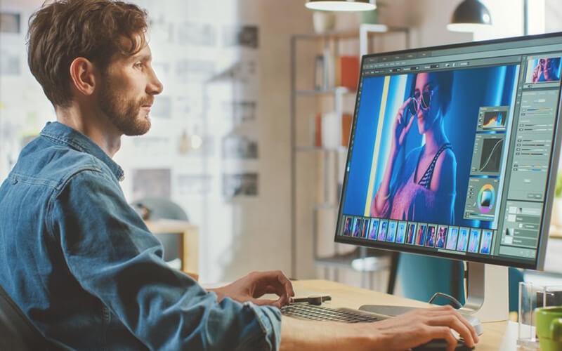 Man working with edits on desktop
