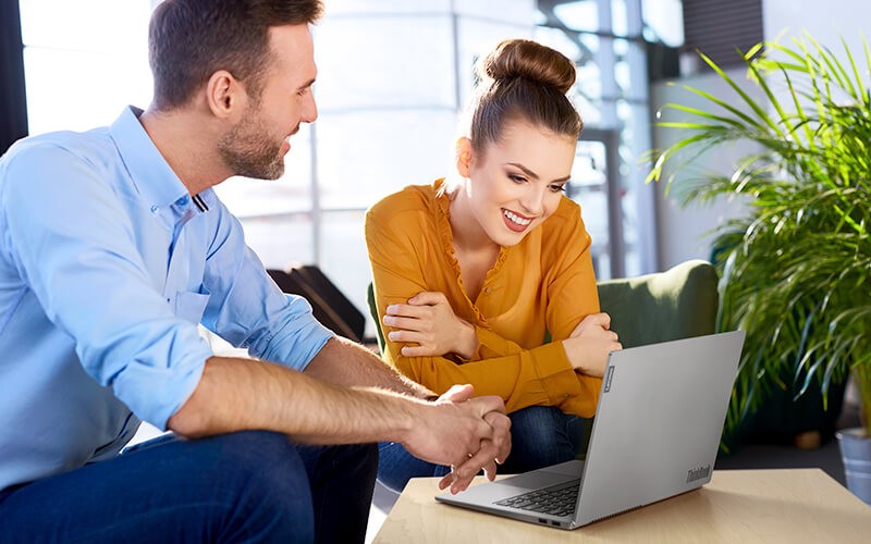 Two person collaborating using Lenovo laptop