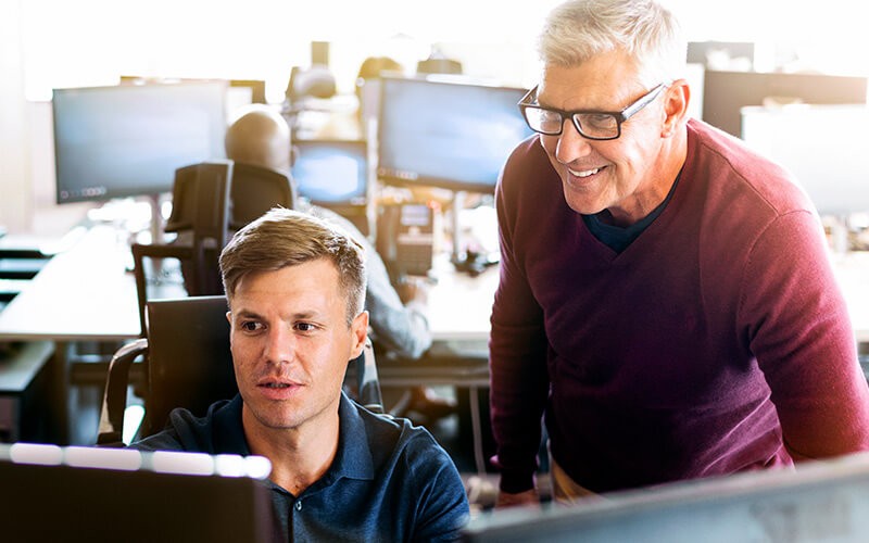 Business intelligence analyst reviewing data with manager