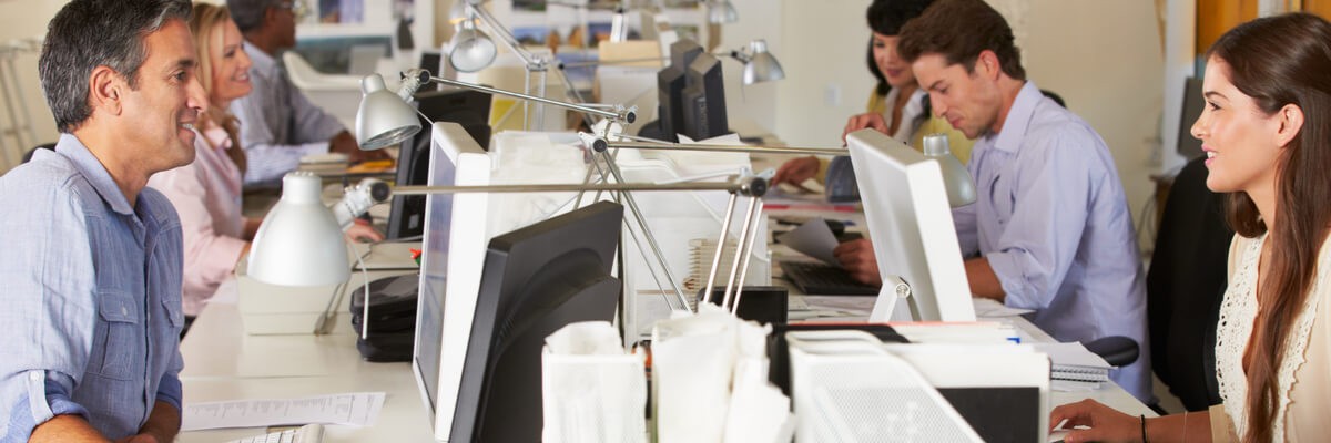 Optimizing Your Long-Term Return With Azure Cloud Services A group of people in an office all happily working on their computing service