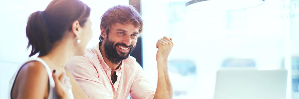 3 IaaS Cloud Computing Trends to watch An image showing two coworkers discussing a fun video project over a laptop