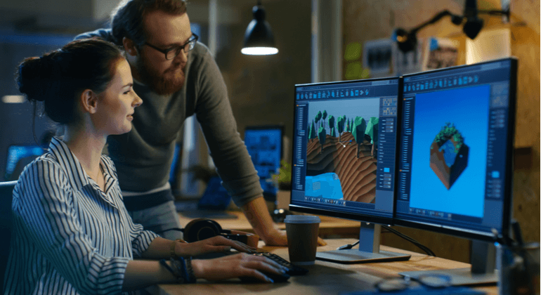 CGI tools A man and women are on the computer designing graphics for a game.