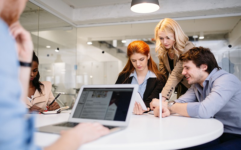Business team meet to discuss customer analytics in conference room